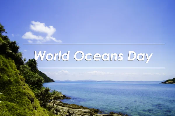 Image concept with word WORLD OCEANS DAY.blurred background the cliff covered with thick foliage