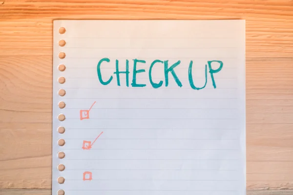 Health check up lists concept, top view paper note on wood table