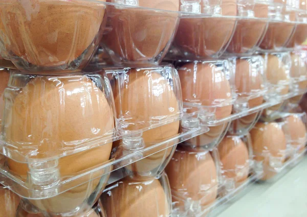 Egg covered by plastic tray on the supermarket shelf