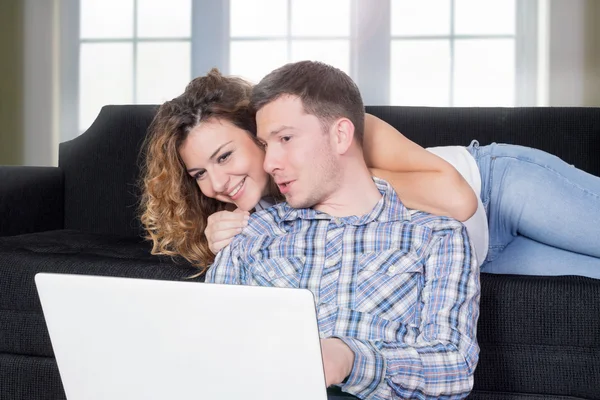 Happy couple using a lap top
