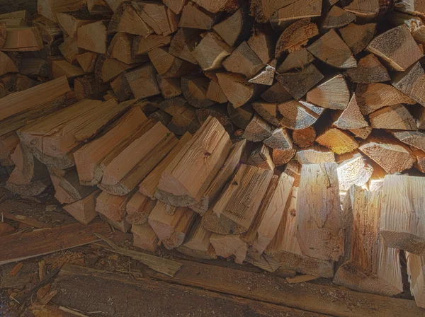 A woodpile of fire wood in a shed