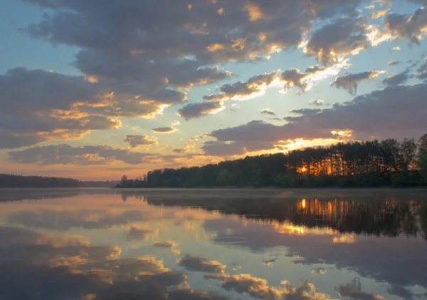 Nature awakens. Sky, lake, dawn.