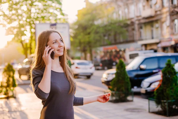 woman in city speaking on mobile phone