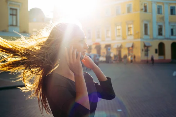 Woman in city speaking on mobile phone