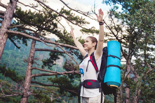 Caucasian hiker woman on trek in mountains with backpack living a healthy active lifestyle. Hiker girl on nature landscape hike in Crimea.