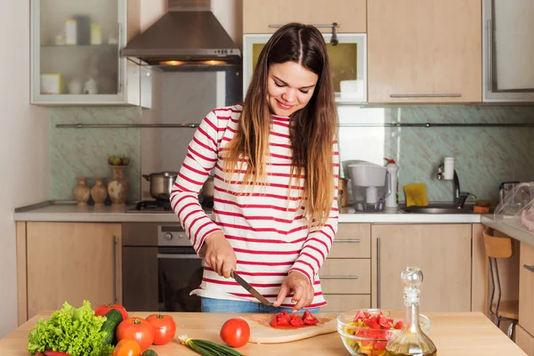 Young Woman Cooking Vegetable Salad.  Dieting Concept. Healthy f