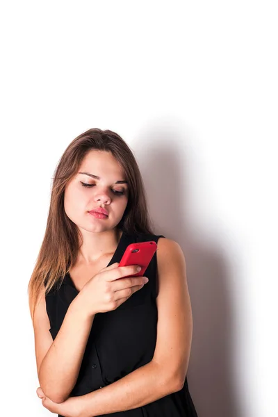 Young angry female speaking on phone isolated on white