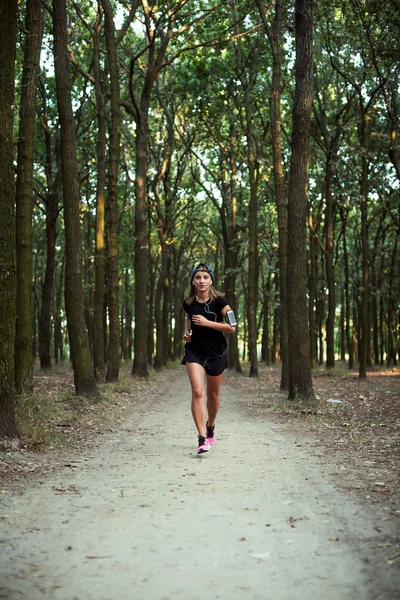 Young caucasian female running in park. Female jogging in park