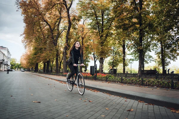 Young female riding a bicycle, girl with fixed gear bike