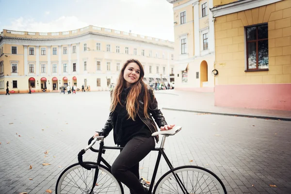 Young female riding a bicycle, girl with fixed gear bike