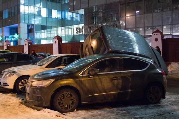 Car parked on roof of the other two