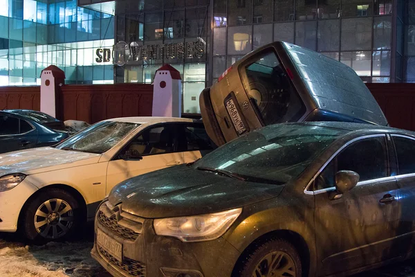 Car parked on roof of the other two