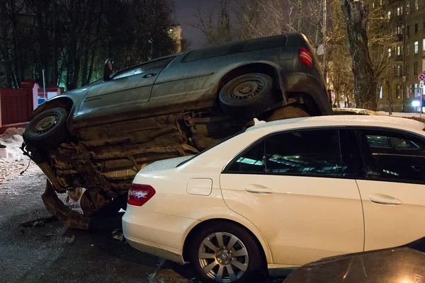 Car parked on roof of the other two