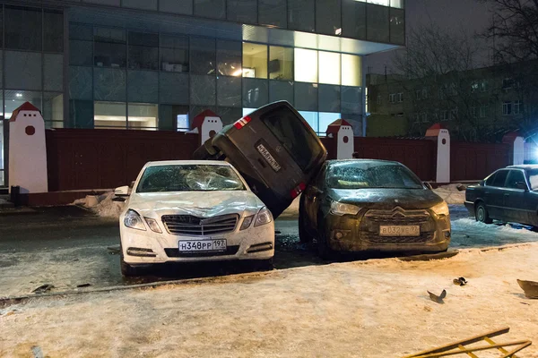 Car parked on roof of the other two