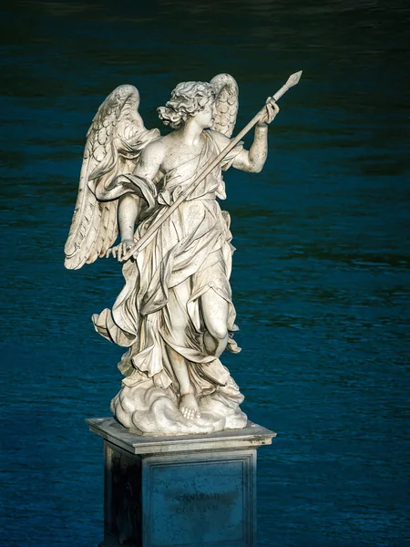 Sun illuminates a statue of an angel on the Ponte Sant`Angelo in