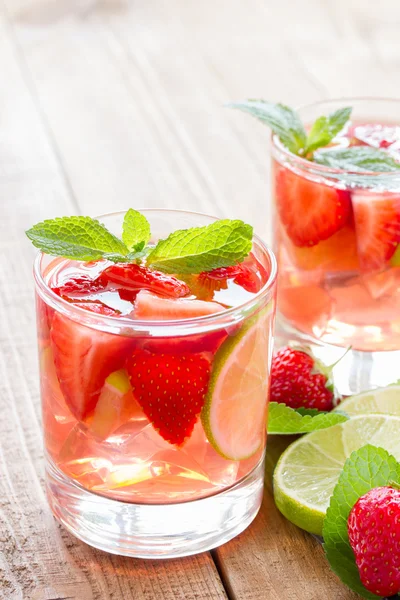 Fresh lemonade with strawberries , lime and mint