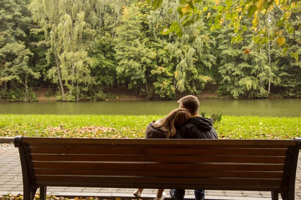 Couple sitting on a bench and hugging