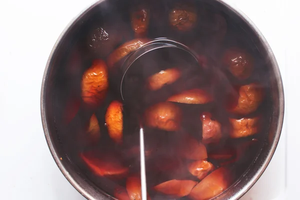 Stewed fruit is cooked on the stove