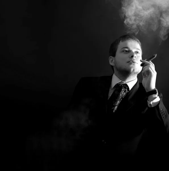 Man in a suit smoking  cigar