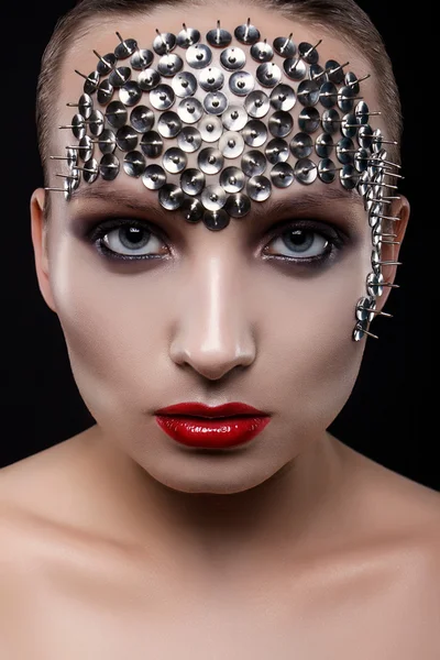 Close-up portrait of a beautiful girl with spikes on his head on