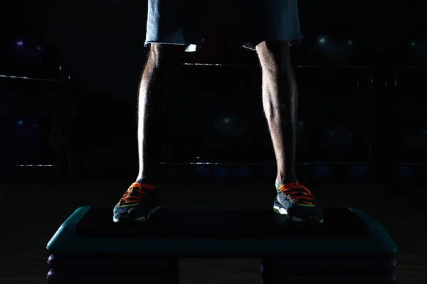 Attractive Young Man Doing Leg Exercises With Machine In Gym