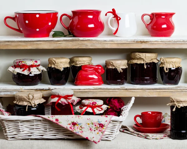 A rustic style. Ceramic tableware and kitchenware in red on the