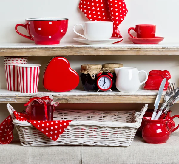 A rustic style. Ceramic tableware and kitchenware in red on the