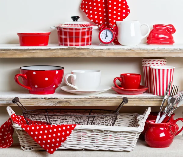 A rustic style. Ceramic tableware and kitchenware in red on the