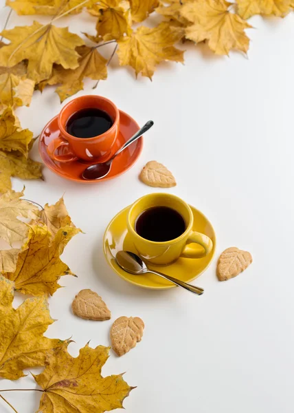 Autumn. Two cups of coffee and cookies in the shape of the leave