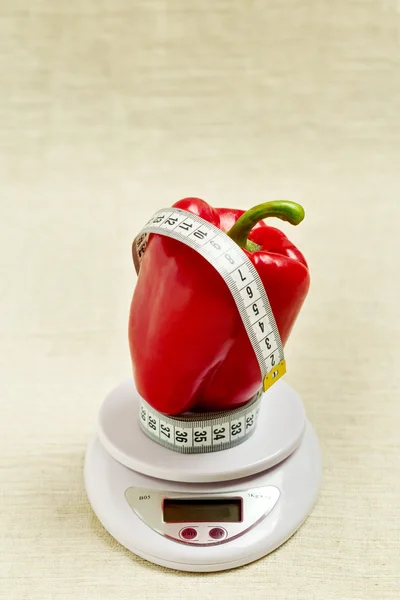 Concept of diet, health. Red sweet bell pepper with a meter on t