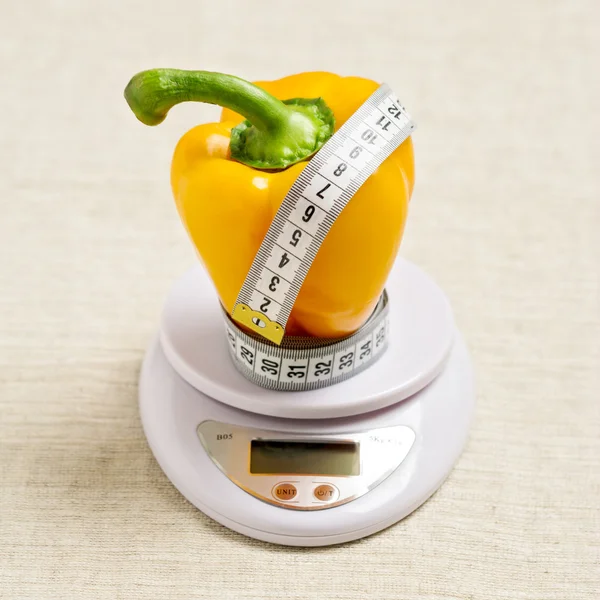Concept of diet, health. Yellow sweet bell pepper with a meter o