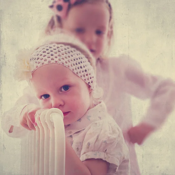 Portrait of beautiful little girls (sisters)  in vintage style.