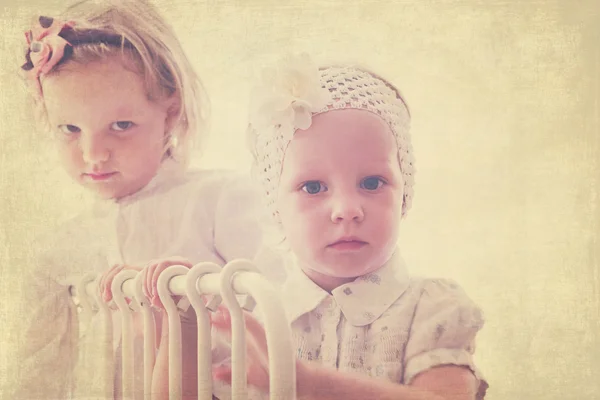 Portrait of beautiful little girls (sisters)  in vintage style.