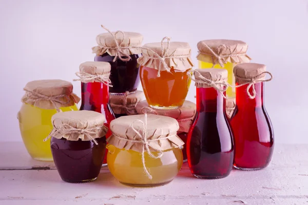 Preserved homemade fruits and berries jam in the jar. Rustic sty