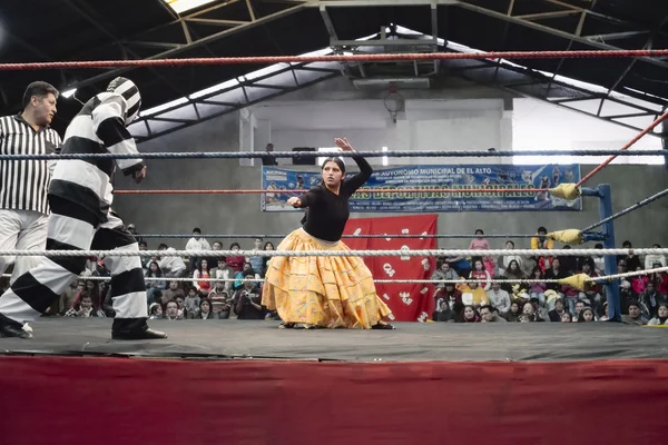 Male and female wrestlers in combat at the Cholitas Wrestling Event