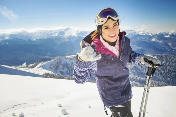 Ski. Happy sport woman in snowy mountains