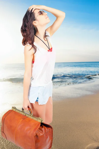 Woman holding hand luggage, summer travel