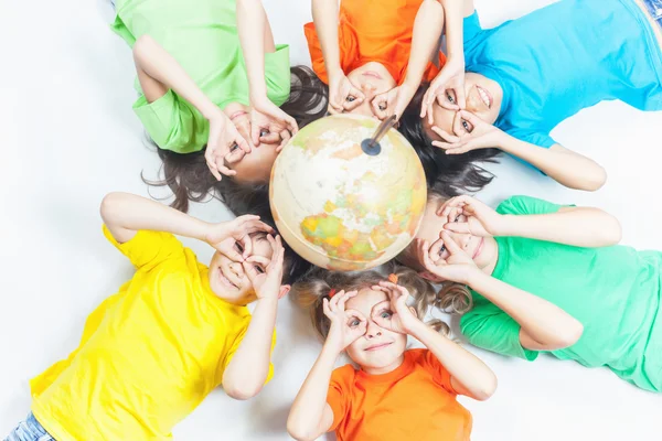 Group of international funny kids with globe earth