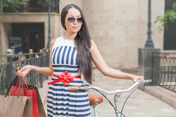 Fashion woman dressed in striped dress with bags