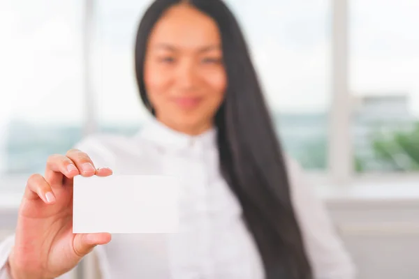 Asian business woman holding card for your contacts