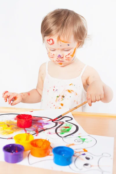 Baby draws with colored inks paint