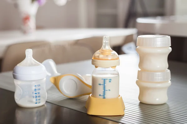 Baby bottle with milk and manual breast pump
