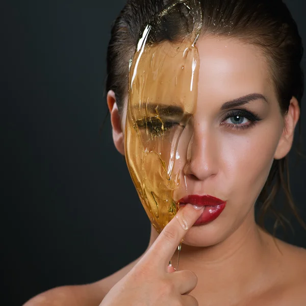 Concept sugaring epilation skin care with liquid sugar near face