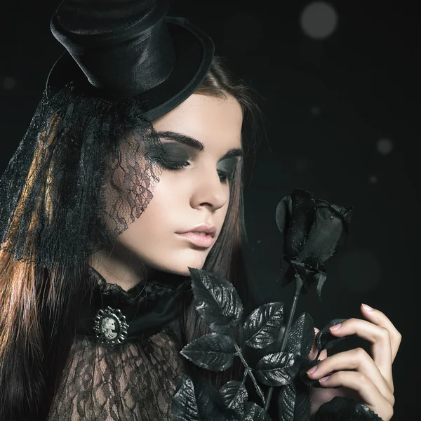 Fashion young woman holding black rose, Halloween party 2016!