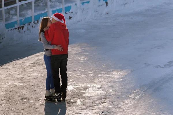 Kissing teen couple at ice rink