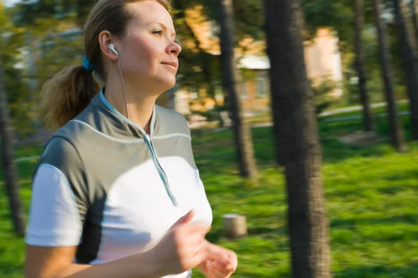 Young attractive woman running in forest