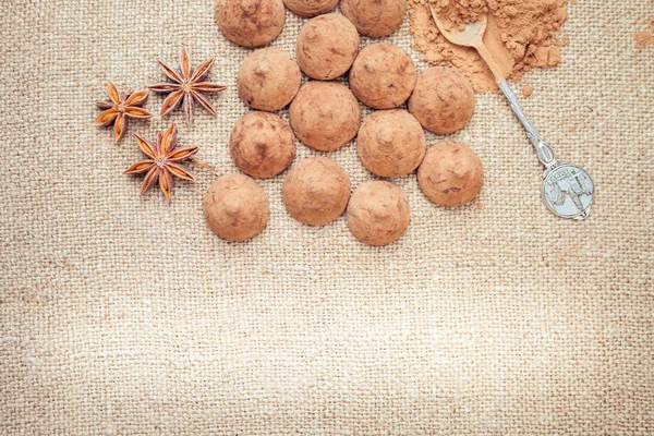 Chocolate truffles candies on a background of burlap bag texture