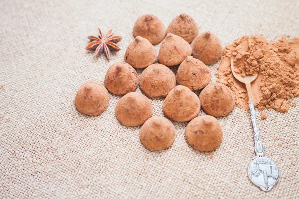 Chocolate truffles candies on a background of burlap bag texture