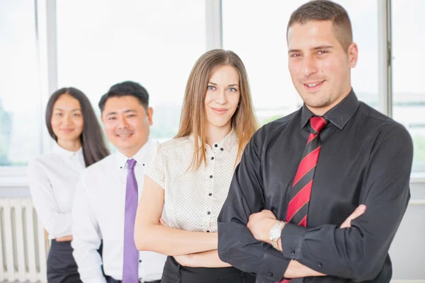 Successful young business man and his business team