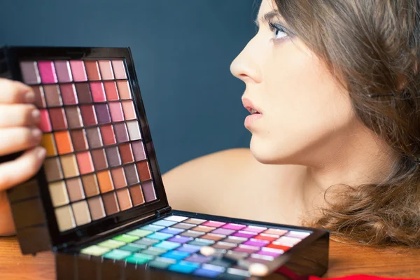 Glamor woman with colorful palette for fashion makeup